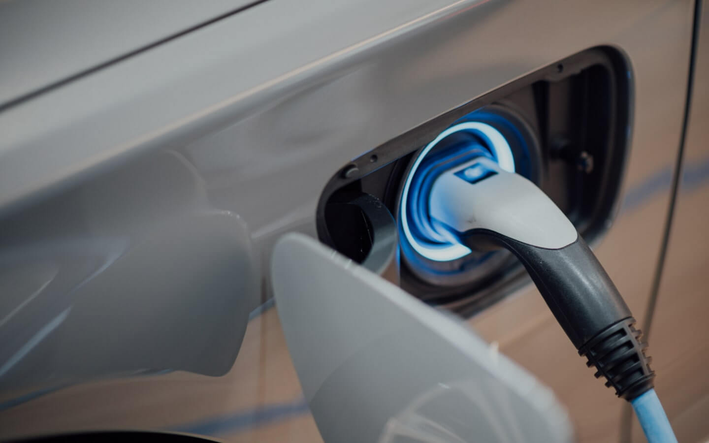Gray electric vehicle using a charger to refuel