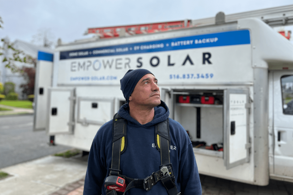 EmPower Solar installer poses in front of the company's truck.