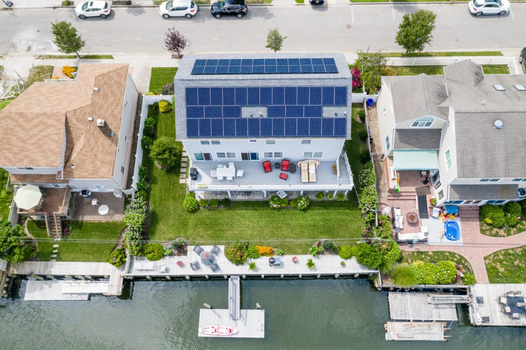 A waterfront house on Long Island has solar panels on the roof to generate clean energy.