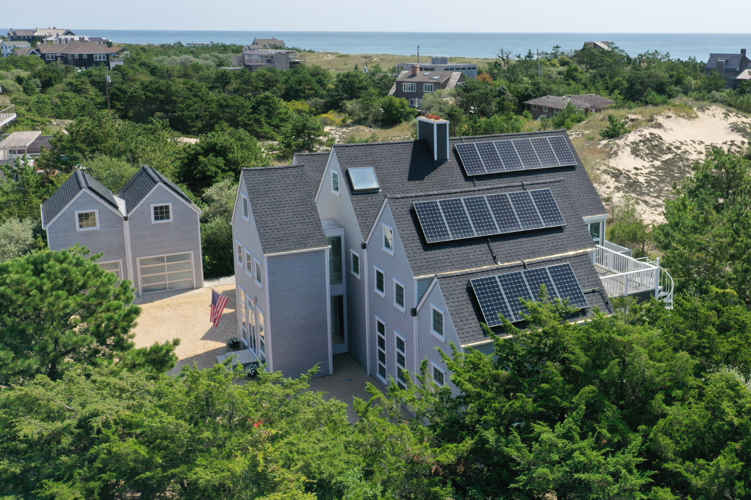 Solar panels on the tiered roof of a house near the ocean on Long Island. The Federal Solar Tax Credit allows homeowners to save money on their taxes when they install solar panels on their home. The Federal Solar Tax Credit allows homeowners to save money on their taxes when they install solar panels on their home.