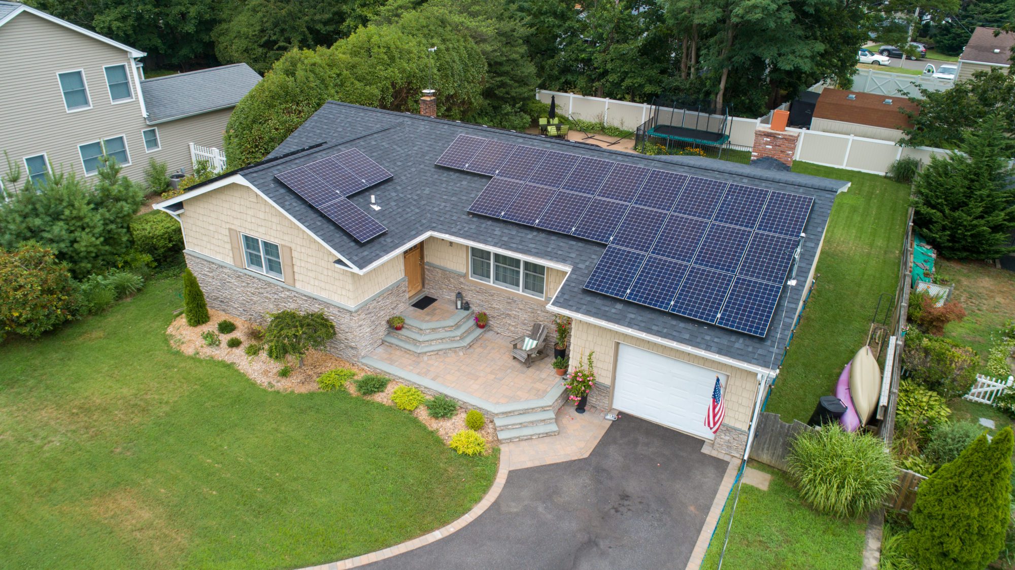 A home with solar panels on the roof. Solar can help you avoid high heating bills this winter.