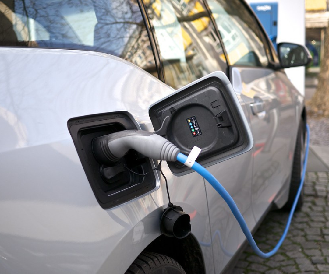 An electric vehicle is plugged into a home charger. Electric cars in winter are highly efficient, and installing a home charger can help improve resiliency and reduce range anxiety.